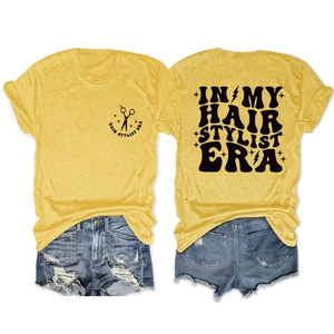 Front and back view of yellow hair stylist t-shirt with retro typography and denim shorts