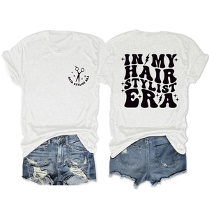 Detail showing white round neck T-shirt with Hair Stylist Era print and denim shorts set