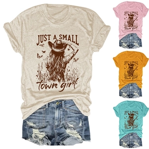 Close-up of graphic tee with cowgirl print and distressed denim shorts detailing
