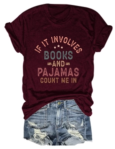 Flat lay of maroon crew neck book lover T-shirt with casual distressed denim shorts