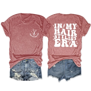Front and back view of brick red hair stylist era tee with blue distressed denim shorts