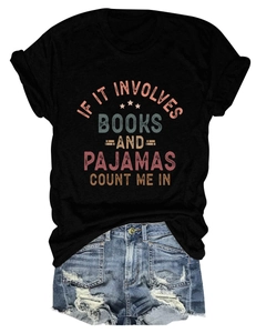 Flat lay detail of black cotton book lover t-shirt with blue distressed denim shorts