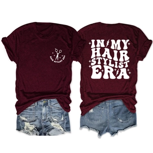 Flat lay of wine red hairstylist t-shirt and distressed denim shorts, showing both sides