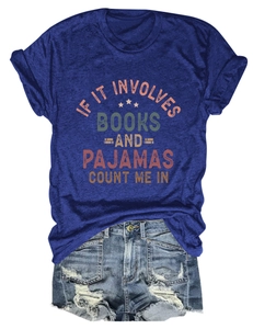 Flat lay of navy blue slogan t-shirt paired with distressed denim shorts on white background