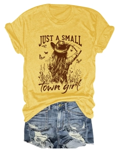 Flat lay detail of mustard yellow t-shirt with Just a Small Town girl print and denim shorts