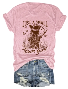 Flat lay of pink t-shirt with Just A Small Town graphic and ripped denim shorts