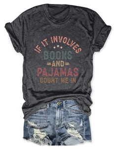 Flat lay of gray book lover T-shirt with pajamas slogan and distressed denim shorts