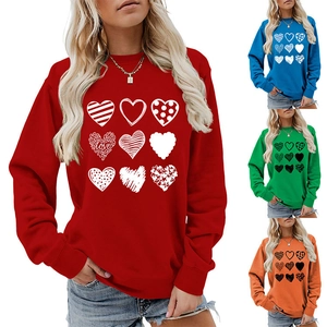 Detail view of colorful heart pattern prints and long sleeve crewneck sweatshirt styles