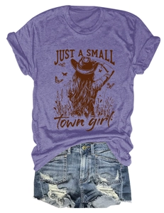 Flat lay of purple cotton T-shirt with small town girl graphic and ripped denim shorts