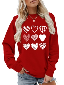 Detail of red crewneck sweatshirt featuring nine white artistic heart prints with love text