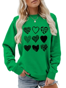 Detail of green crewneck sweatshirt featuring nine unique black heart prints and LOVE text