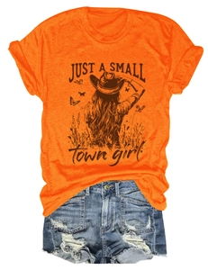 Flat lay of an orange T-shirt with Just a Small Town Girl print and distressed denim shorts