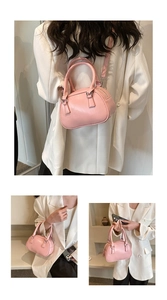 Detail of pink mini bowling bag showing smooth glossy texture and crossbody strap