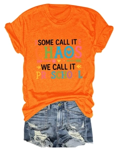 Détail du t-shirt orange imprimé avec un short en jean bleu délavé et déchiré