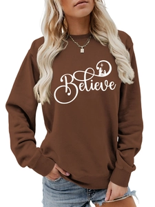 Close-up of dark brown cotton sweatshirt featuring white Believe Nativity graphic print