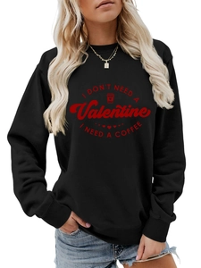 Close-up of the red slogan print on a black long-sleeved sweatshirt for women