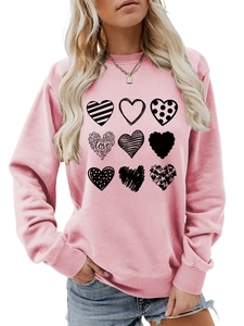 Detail of pink sweatshirt featuring nine unique black heart prints and love text