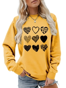 Detail of ginger yellow crew neck sweatshirt with 3x3 black heart pattern print