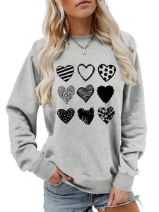 Detail of grey crewneck sweatshirt featuring nine stylish black heart prints with love text