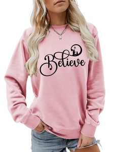 Front view of pink crewneck sweatshirt featuring Believe text and Nativity silhouette