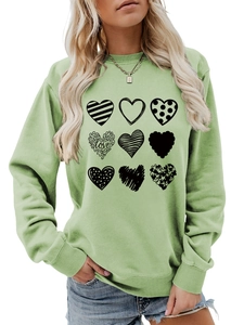 Detail of printed Nine hearts with LOVE text on green crewneck sweatshirt fabric