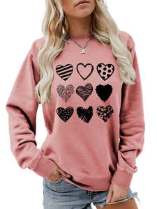 Detail of dusty rose crewneck sweatshirt featuring nine unique black heart graphic prints
