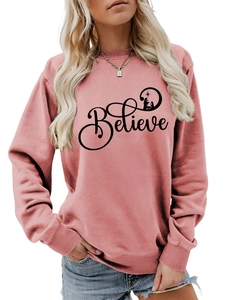 Detailed view of the ribbed cuffs and Believe graphic on a dusty pink sweatshirt