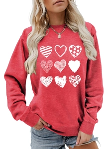 Detail view of the soft cotton red crewneck sweatshirt with nine white artistic heart patterns