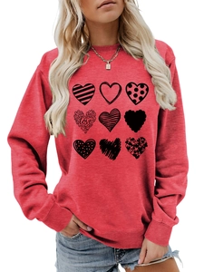 Detail of red crewneck sweatshirt with nine black love hearts and artistic typography