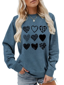 Detail of nine heart patterns with various textures and love script on blue sweatshirt