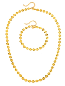 Detailed close-up of golden sunburst embossed disk link necklace and bracelet jewelry set