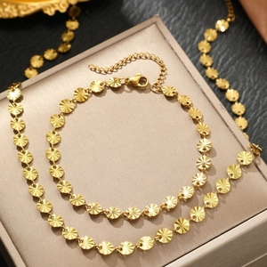 Minimalist gold sunburst embossed disc necklace and bracelet set in stainless steel