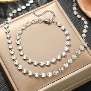Minimalist stainless steel necklace and bracelet set with embossed sunburst round discs