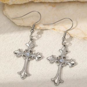 Gothic vintage stainless steel cross earrings with white zircon on stone background