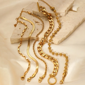 Golden multi-layer chain bracelet set with OT toggle clasp and snake chain on silk