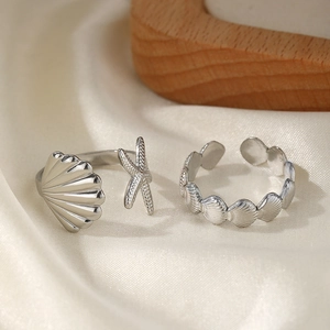 Polished silver starfish and shell open adjustable rings set with ocean elements