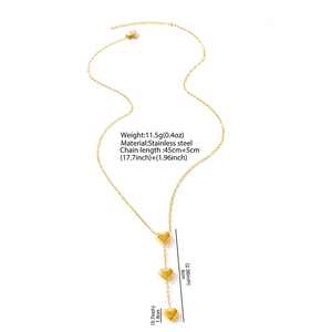 Detail view of golden stainless steel necklace with three vertical 3D heart pendants