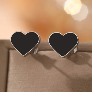Minimalist heart-shaped stud earrings with black enamel inlay and silver-tone metal frame