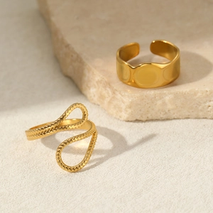 Detail of 18K gold-plated irregular adjustable ring set on natural beige stone