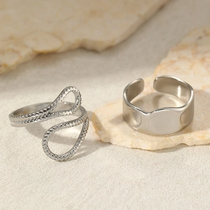 Irregular silver stainless steel ring set with textured weave and wave patterns