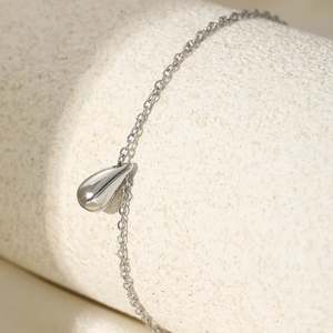 Elegant silver-colored stainless steel teardrop pendant bracelet with a polished finish
