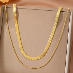 Double-layered 18K gold plated stainless steel snake bone necklaces on a jewelry display