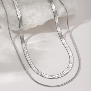 Detail of silver double layered snake bone chain necklaces in polished stainless steel