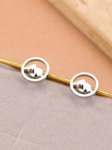 Detailed close-up of silver mountain silhouette earrings made of polished stainless steel
