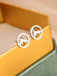 Close-up of polished stainless steel mountain earrings displayed on a gift box