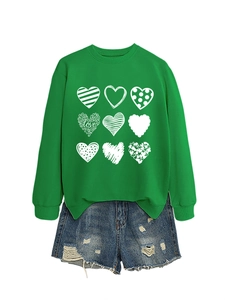 Flat lay of grass green crewneck sweatshirt with nine hearts and denim shorts