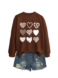 Detail of heart patterns and LOVE text print on a brown crewneck sweatshirt