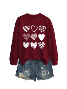 Detail of heart patterns and LOVE text print on a dark red crewneck sweatshirt