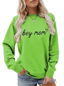 Detail of neon green crewneck sweatshirt featuring black boy mom print and heart icon