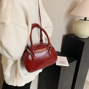 Glossy burgundy leather Boston bowling bag with silver hardware and detachable strap